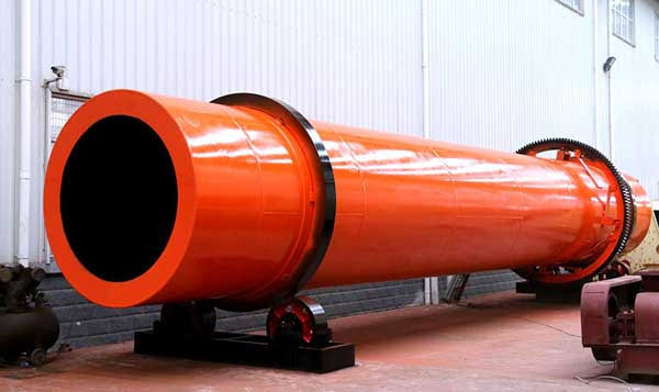 Rotary kiln dryer with drive motor and gear system.